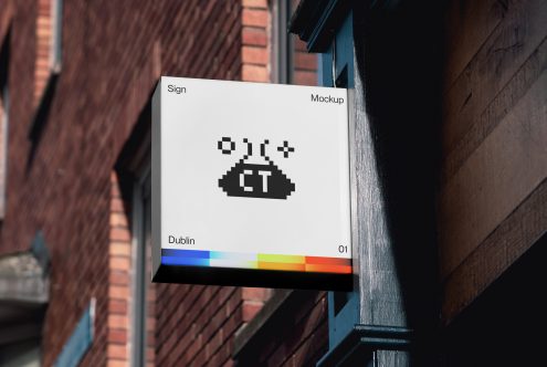 Urban signboard mockup hanging on a building wall with a pixel art design display in an outdoor setting, ideal for showcasing branding designs.